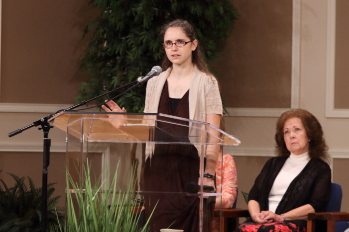 Rita Braeshear listening to Anna Quigley share her testimony.