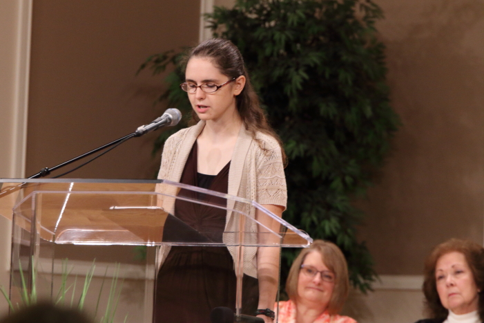 Beth Bartlett and Rita Braeshear listening to Anna Quigley share her testimony.